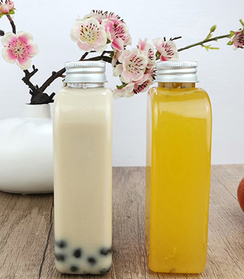 帽子が付いているジュースのミルク400mlの平らなプラスチック飲むびん